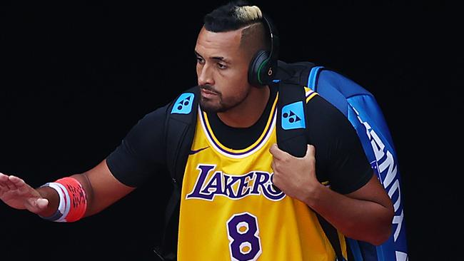 Nick Kyrgios heads onto court in the iconic Lakers no.8 jersey.