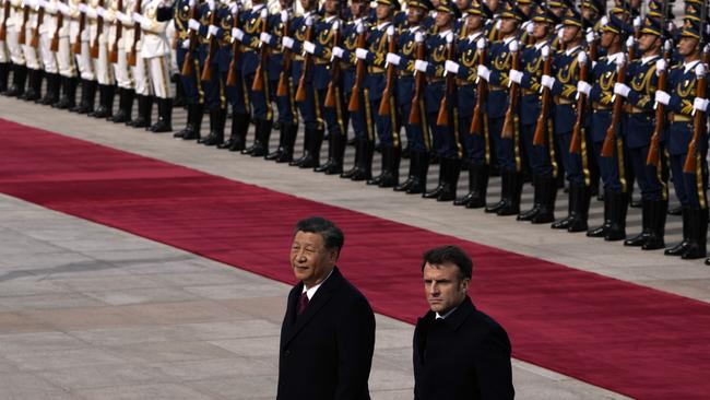 French President Emmanuel Macron with Chinese President Xi Jinping during a welcome ceremony outside the Great Hall of the People. Picture: Getty