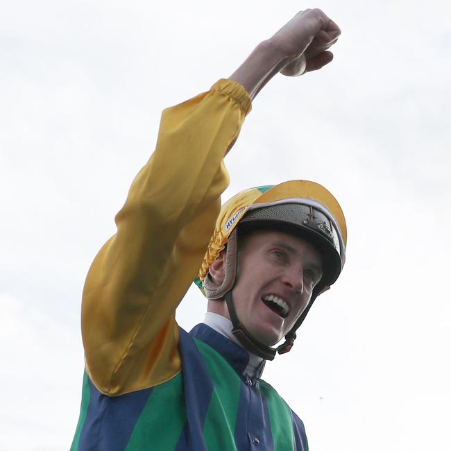 Spoils of victory … Chad Schofield salutes after winning the Epsom aboard Ceolwulf. Picture: Jeremy Ng / Getty Images