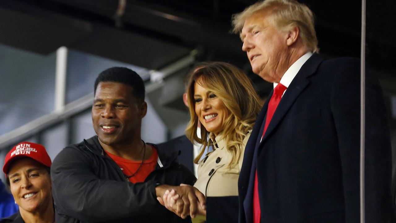 Trump attended the game alongside former football player and political candidate Herschel Walker. (Photo by Michael Zarrilli/Getty Images)
