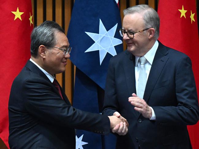 China's Premier Li Qiang (L) and Australia's Prime Minister Anthony Albanese shake hands during a signing ceremony at Parliament House in Canberra on June 17, 2024. (Photo by LUKAS COCH / POOL / AFP)