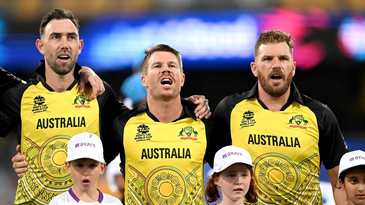 BRISBANE, AUSTRALIA - OCTOBER 31: Glenn Maxwell, David Warner and Aaron Finch of Australia embrace for their national anthem before the ICC Men's T20 World Cup match between Australia and Ireland at The Gabba on October 31, 2022 in Brisbane, Australia. (Photo by Bradley Kanaris/Getty Images)