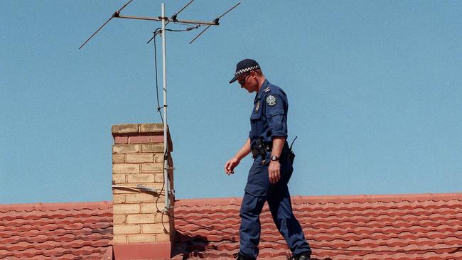 A STAR Group officer searching a roof of an Elizabeth South home looking for clues after the murder.