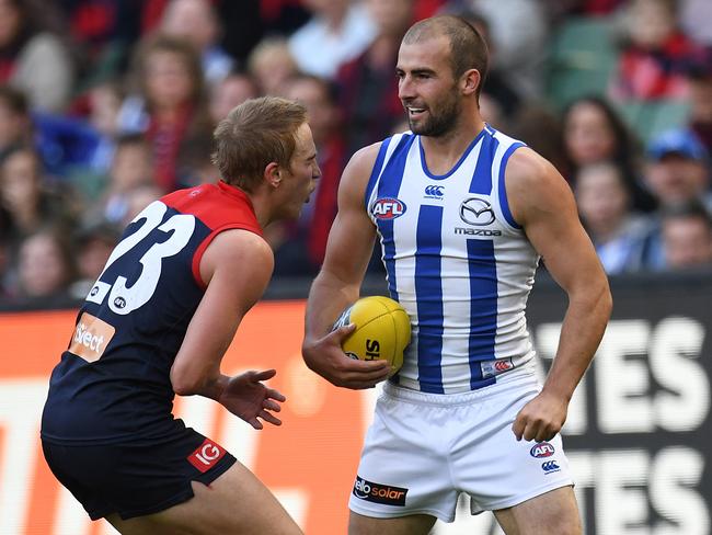 Bernie Vince cops a blow to the stomach from Ben Cunnington. Picture: AAP