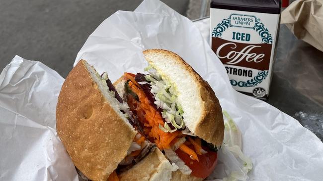 A sandwich at Cheviot Snack Bar, paired with a strong Farmers Union Iced Coffee. Picture: Jason Katsaras