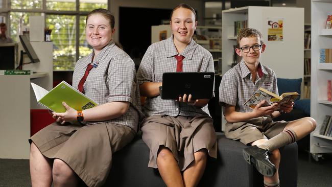 Students Erin Brown, Morgan Lock and Dean Scott posing at St Benedict's College at Mango Hill. Picture: AAP /Josh Woning