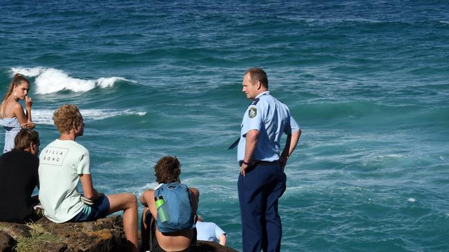 Tweed Byron Police District Superintendent Wayne Starling talks to a drowning victim’s friends at Fingal Head Lighthouse earlier this year.