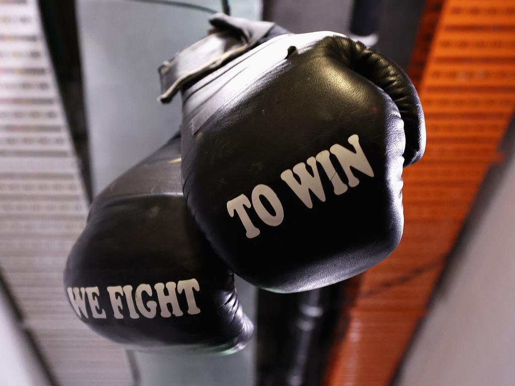 A pair of boxing gloves hang from the doorway of the Lions changeroom. Picture: Getty Images