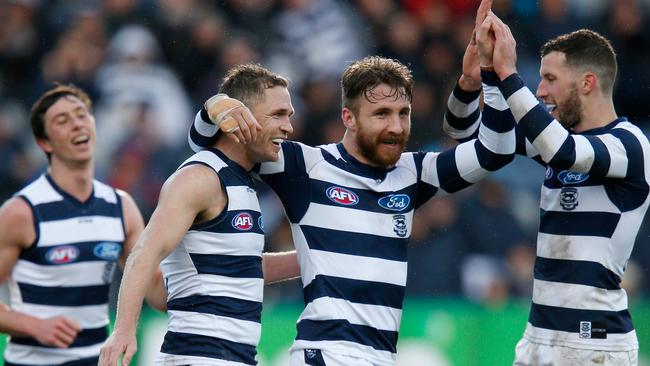 Geelong’s Zach Tuohy celebrates a goal with Joel Selwood and Sam Menegola as the Cats got rolling Pic: Getty Images