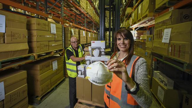 Lyndon Rowe and Edurne Esparza unpack the millions of masks SA has received. Picture: Roy VanDerVegt