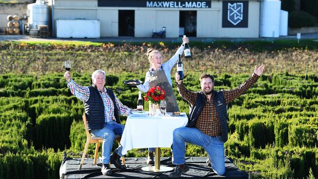 Maxwell wineries owner Mark Maxwell and son and general manager Jeremy Maxwell celebrate the reopening of the Fleurieu with cellar door staffer Katie Whish on a platform dining above their maze Picture Mark Brake