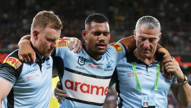 SYDNEY, AUSTRALIA - MARCH 27:  Sione Katoa of the Sharks is assisted from the field after sustaining an injury during the round three NRL match between the Parramatta Eels and the Cronulla Sharks at Bankwest Stadium on March 27, 2021, in Sydney, Australia. (Photo by Matt King/Getty Images)