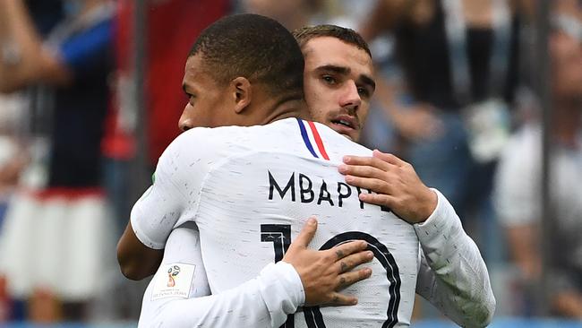 French attacking duo Antoine Griezmann (right) and Kylian Mbappe embrace during their team’s World Cup quarter-final victory over Uruguay. Photo: AFP