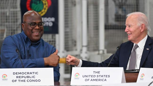 Democratic Republic of Congo (DRC) President Felix Tshisekedi (L) reacts after shaking hands with US President Joe Biden (R) while attending the Lobito Corridor Trans-Africa Summit.