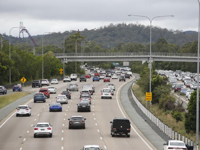 Slow moving traffic along the M1 near Oxenford, Gold Coast, Saturday, January 18, 2020. The M1 was closed for several hours in the morning due to flash flooding at Exit 57 after a severe thunder storm swept the Coast during the early hours of the day dumping 128mm of rain in an hour. (AAP Image/Regi Varghese)