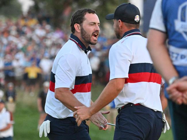 A hatless Patrick Cantlay celebrates coming from behind to beat Rory McIlroy’s team and keep US hopes alive at the Ryder Cup. Picture: Alberto PIZZOLI / AFP