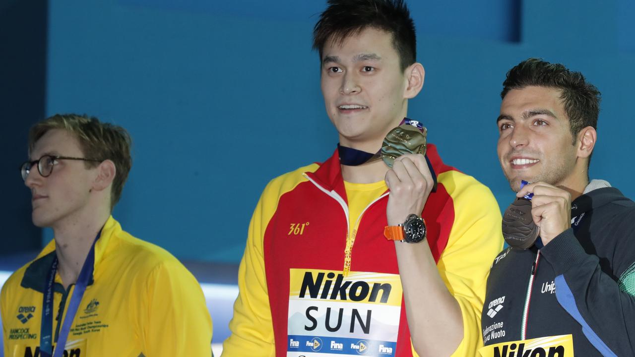 I can’t even look at you .... Mack Horton looks away as gold medallist Sun Yang from China, centre, and bronze medalist Italy's Gabriele Detti show off their medals. Picture: AP