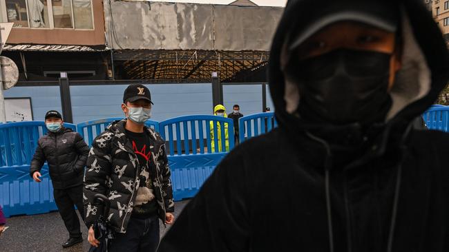 Security personnel stand outside the closed Huanan Seafood wholesale market. Picture: Hector Retamal/AFP