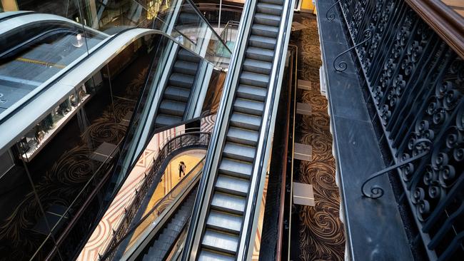 A woman walks through a deserted Queen Victoria Building in Aptil last year. (Photo by Cameron Spencer/Getty Images)