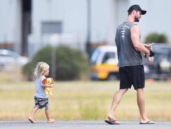 Chris Hemsworth is followed by one of his young children at Adelaide airport. Picture: Mark Brake