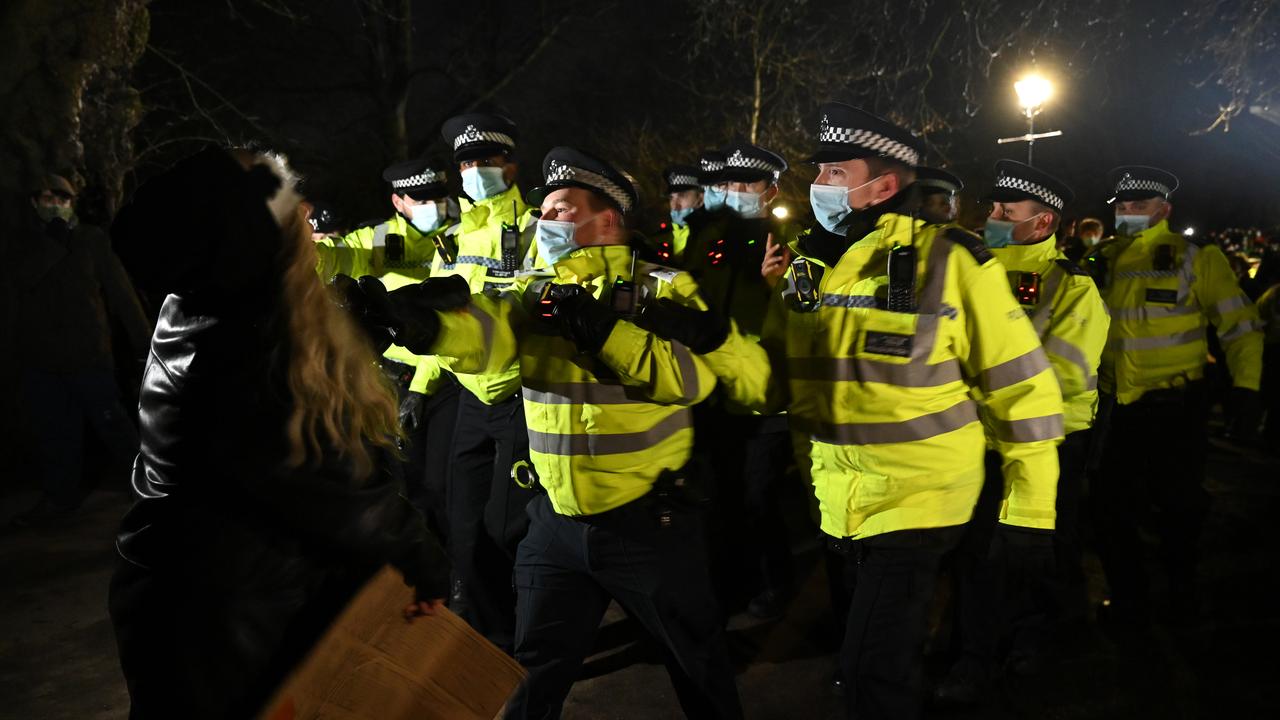 Police Officers arrest a woman during a vigil on Clapham Common, where floral tributes have been placed for Sarah Everard. Picture: Leon Neal/Getty Images