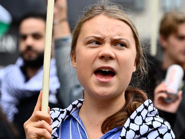 Swedish climate activist Greta Thunberg, wearing a checkered head scarf (kaffiyeh or keffiyeh), takes part in a demonstration organised by forty Swedish social justice movements under the message "People Not Profit - that human life should be valued over economic profit" in central Stockholm, Sweden, on September 21, 2024. (Photo by Anders WIKLUND / TT NEWS AGENCY / AFP) / Sweden OUT