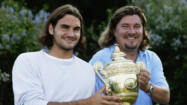 Federer and Lundgren hold the Wimbledon trophy. Photo by Phil Cole/Getty Images