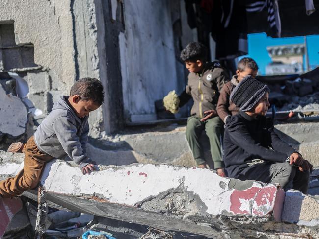 Palestinian children sit among the rubble in Rafah. Picture: Getty Images