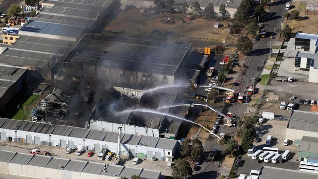 The risk of collapse remains, so firefighters fight the blaze from outside. Picture: Alex Coppel