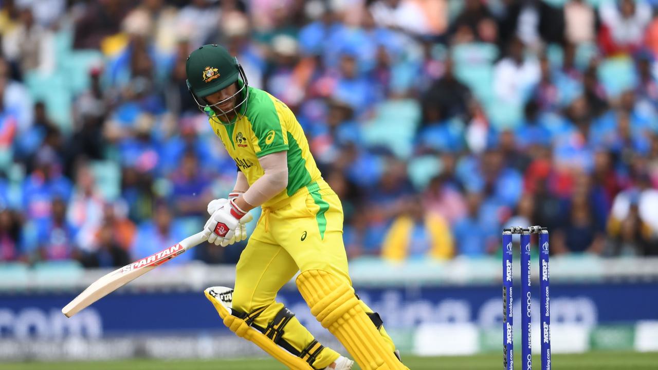 Australia's David Warner looks back as the ball touches his stumps but does not dislodge the bails
