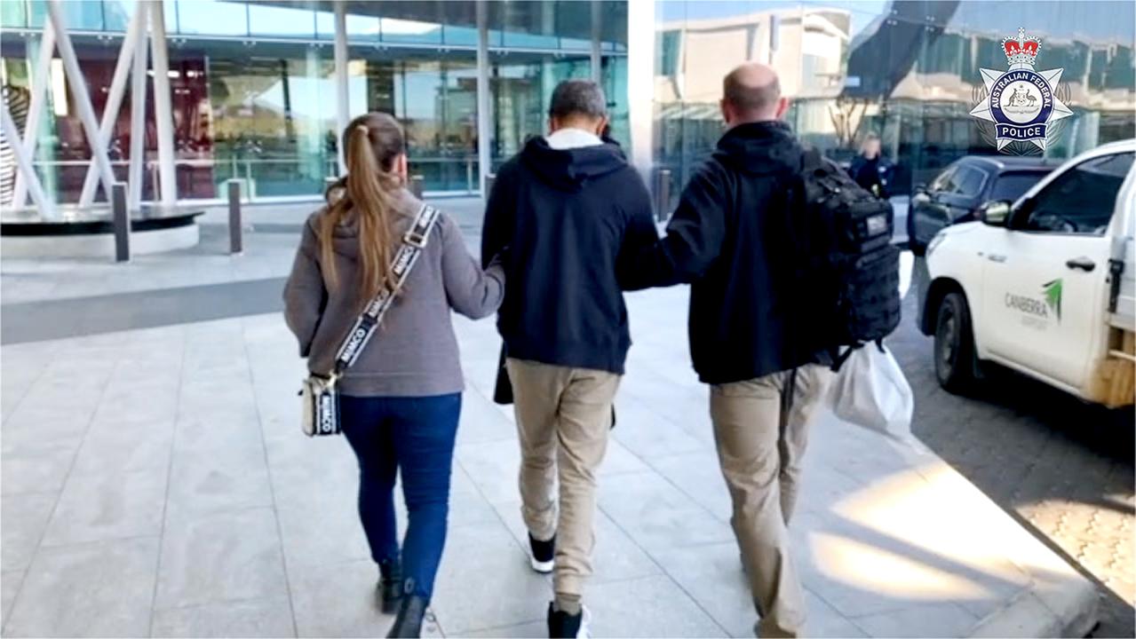 The Australian Federal Police released an image of one of the men, centre, who was extradited to Brisbane on the weekend.