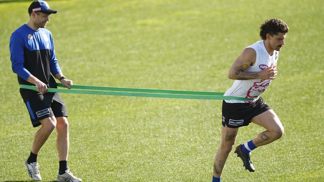 Tom Liberatore completing resistance training at Whitten Oval after being ruled out of this weekend’s knockout clash against Fremantle. Picture: Getty Images