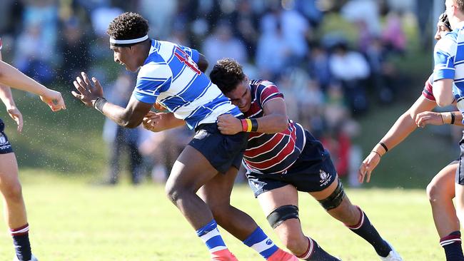 Nudgee College centre Lastus Auakai tackled by The Southport School flanker Ngiyaani Waters. Photo by Richard Gosling