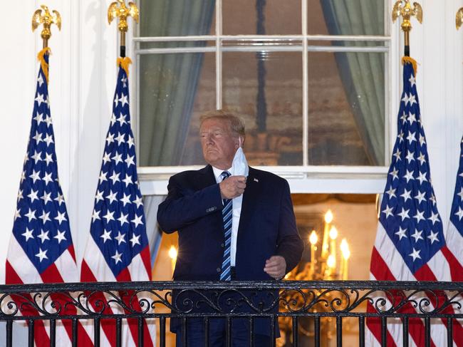 WASHINGTON, DC - OCTOBER 05:  U.S. President Donald Trump removes his mask upon return to the White House from Walter Reed National Military Medical Center on October 05, 2020 in Washington, DC. Trump spent three days hospitalized for coronavirus. (Photo by Win McNamee/Getty Images)