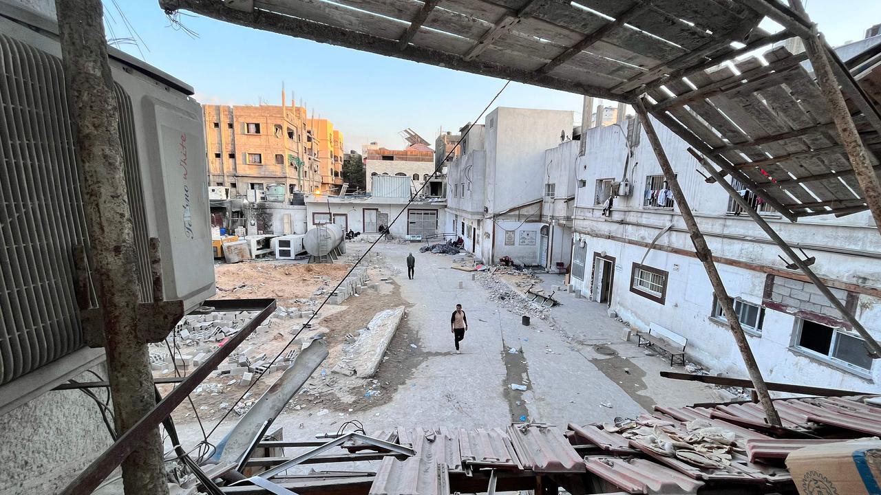 People walk amid the destruction in the vicinity of the Kamal Adwan hospital in Beit Lahya in the northern Gaza Strip on October 31, 2024. (Photo by AFP)