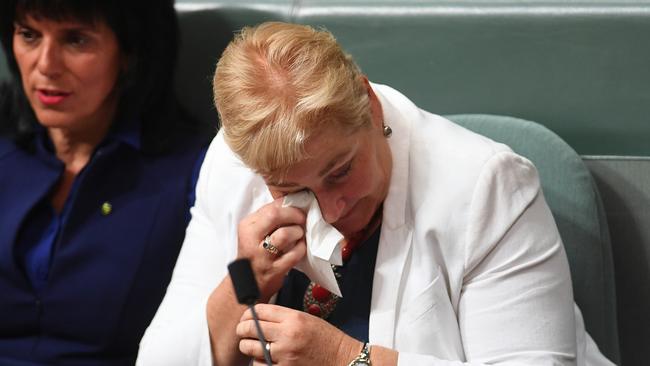 Liberal MP Ann Sudmalis wipes away tears during House of Representatives Question Time at Parliament House in Canberra, Wednesday, March 1, 2017. (AAP Image/Lukas Coch) NO ARCHIVING