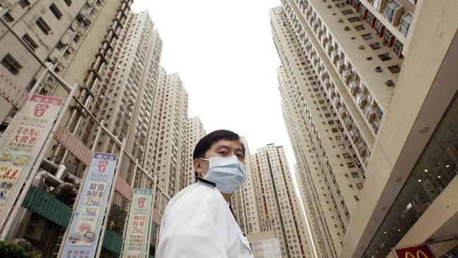 A security guard at Amoy Gardens apartment complex in Hong Kong during the 2003 SARS outbreak.