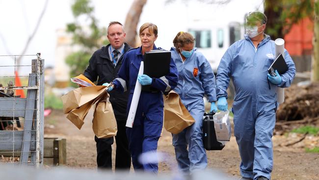 Police remove evidence from a house on Patullos Rd, Lara, where a man was killed. Picture: Alison Wynd
