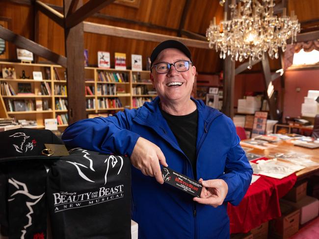 Beauty and the Beast choreographer-turned-director Matt West, pictured inside the Princess Theatre archives with merch from the ‘90s production of the show. Picture: Jason Edwards