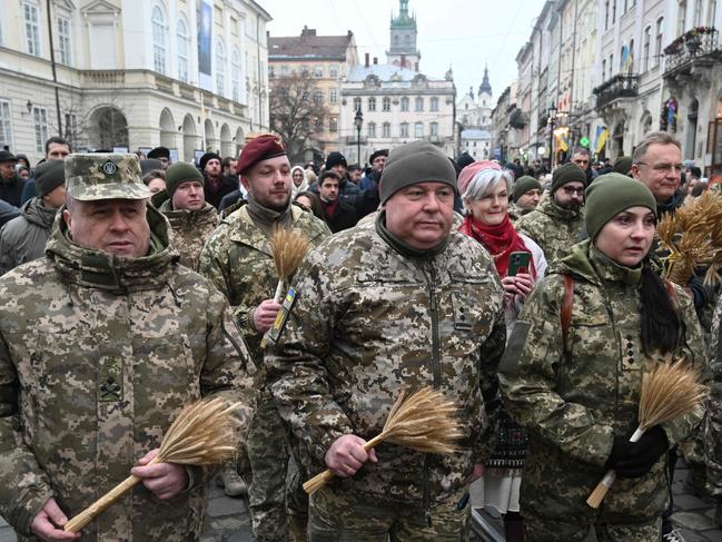 Ukrainian soldiers carry 'didukh' as they take part in a Christmas Eve procession in Lviv. Picture: AFP