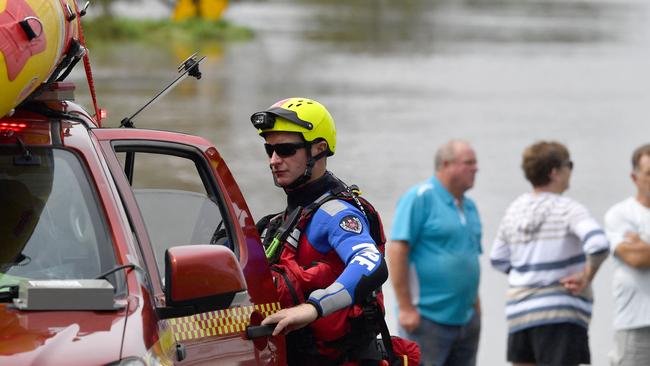 A State Emergency Services (SES) volunteer unloads a boat to visit the a flood affected area in Lawrence on March 1, 2022. Photo: SAEED KHAN / AFP