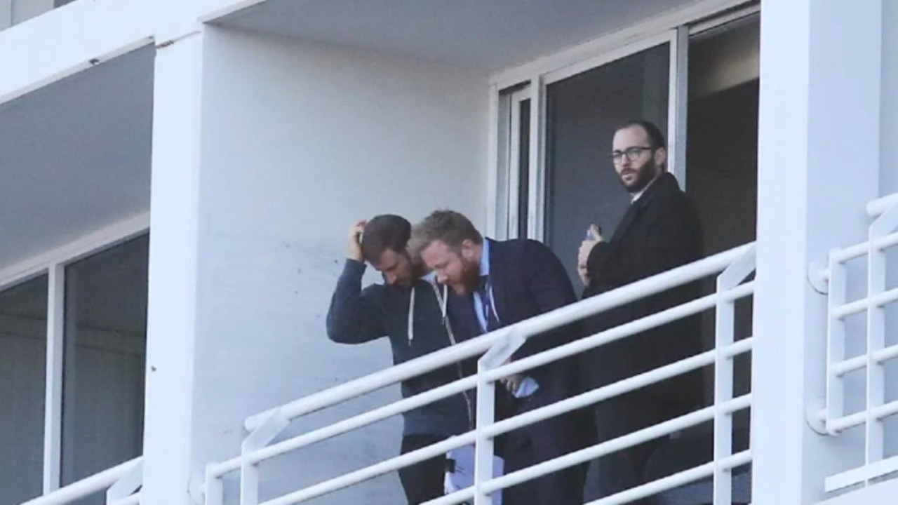 Detectives on the balcony from where the woman fell last night. Picture: David Swift