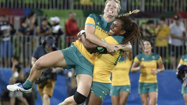 Australia's Ellia Green lifts up a teammate after the sevens team won gold in Rio.