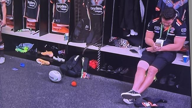 James Roberts on his mobile in Wests Tigers’ dressing room