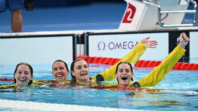 Australian swimmers Mollie O'Callaghan, Emma McKeon, Jenna Strauch and s Kaylee McKeown celebrated the end of the Paris Olympic Games by jumping into the pool. Picture: Jonathan Nackstrand / AFP