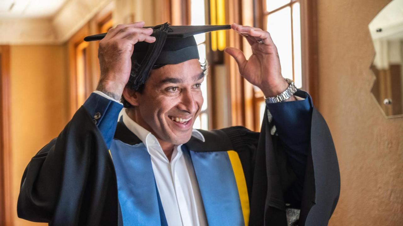 Johnathan Thurston adjusts his mortarboard after being conferred with the honorary title of Fellow of the University of Southern Queensland at the Empire Theatre, Toowoomba, December 15, 2022.