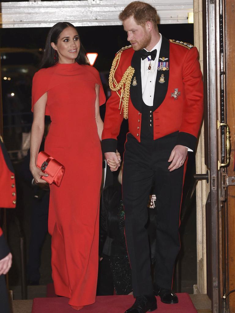 The couple smiled as they were given a round of applause by the crowd. Picture: Eddie Mulholland/Pool via AP.