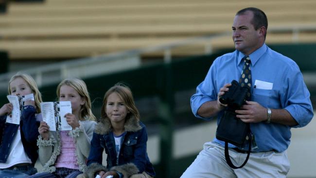 Butter wouldn’t melt: Celine, Breann and Cara have always hung at the races with dad Peter, pictured here in 2004, when the twins were seven. Picture: Nicole Garmston