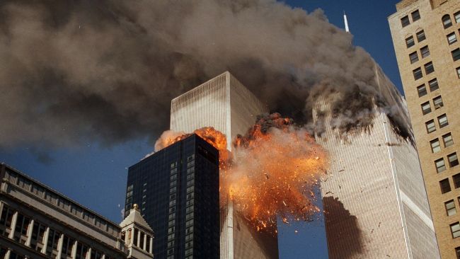Smoke billows from one of the towers of the World Trade Center as flames and debris explode from the second tower on September 11, 2001. Picture: AP/Chao Soi Cheong