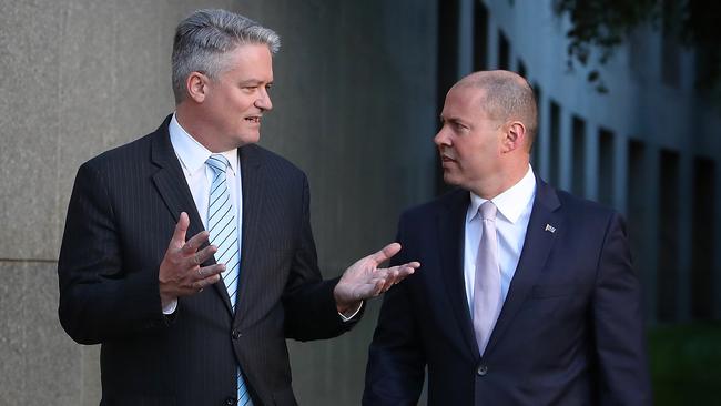 Treasurer Josh Frydenberg, right, with Finance Minister Mathias Cormann in the courtyard at Parliament House last night. Picture: Kym Smith